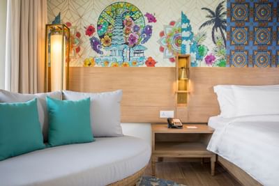 Sofa & bed in Deluxe Room at Eastin Ashta Resort Canggu