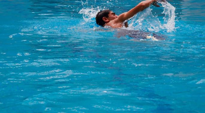 A man swimming in the pool at Islamabad Serena Hotel