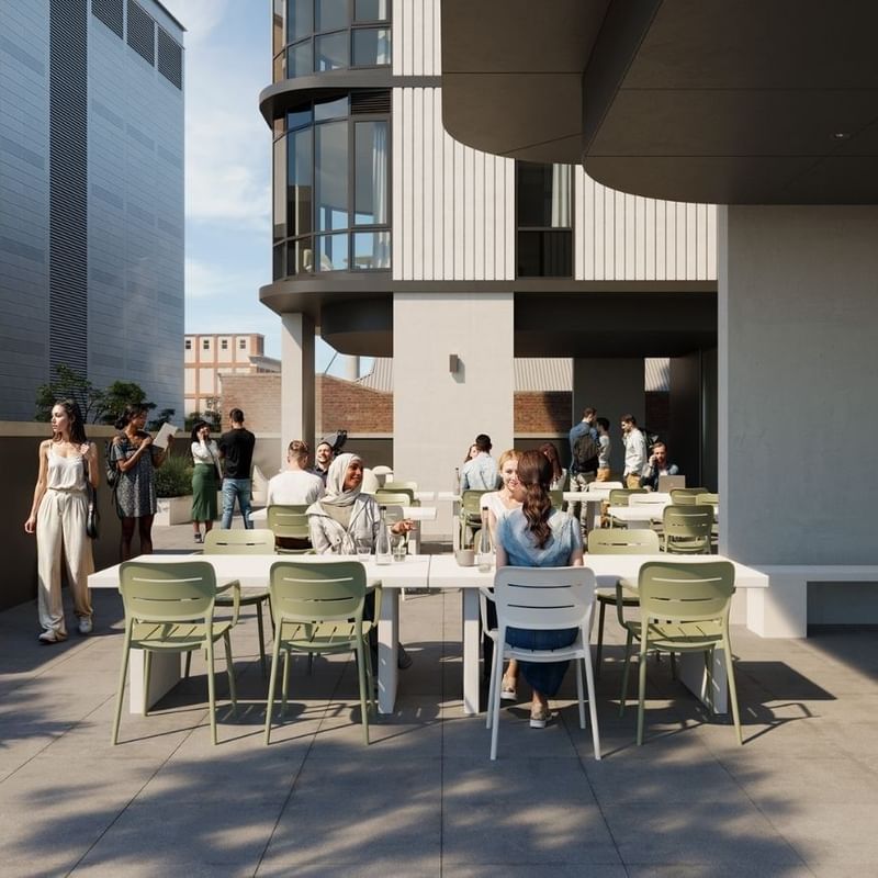Rendering of an outdoor terrace with people seated at tables, surrounded by modern buildings.