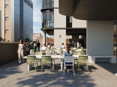 Rendering of an outdoor terrace with people seated at tables, surrounded by modern buildings.