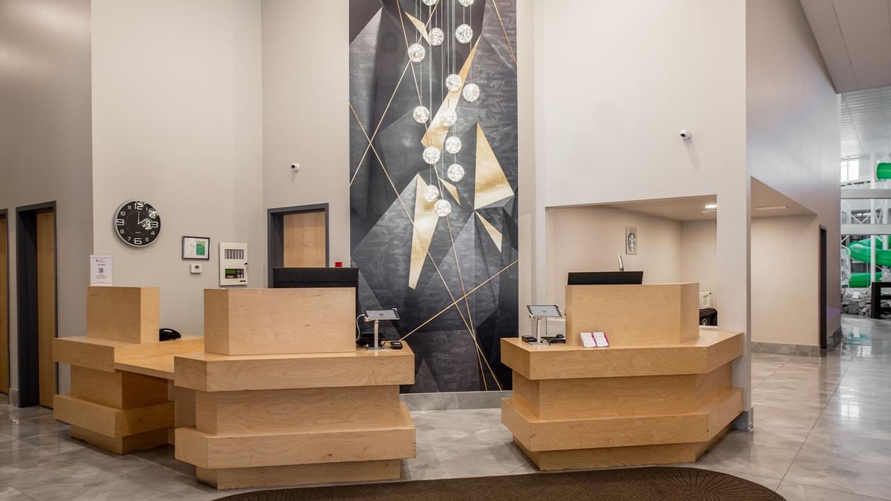 Modern hotel lobby with reception desks.