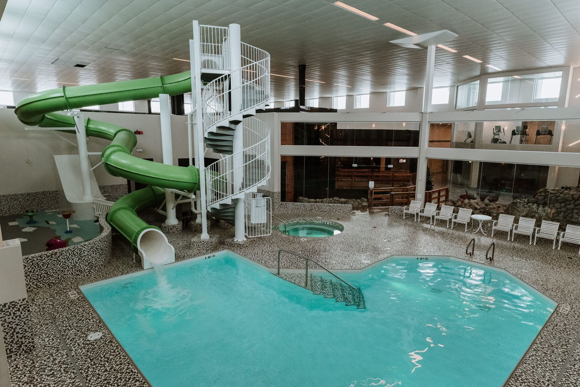 Indoor pool with green waterslide