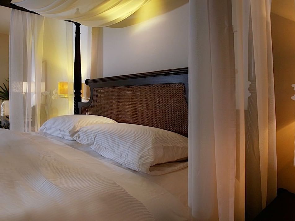 A queen size bed in a room at Casa Colonial Beach and Spa
