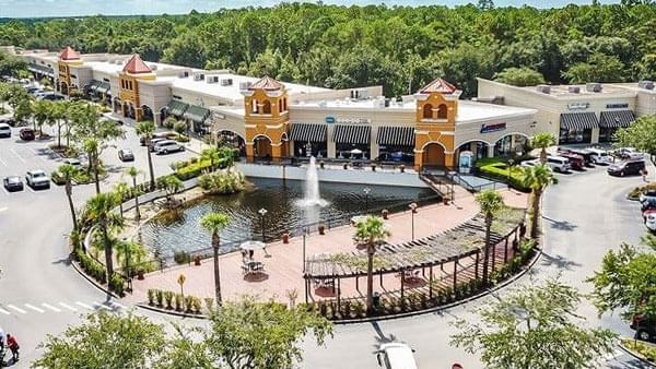 Aerial view of a shopping center with a fountain.