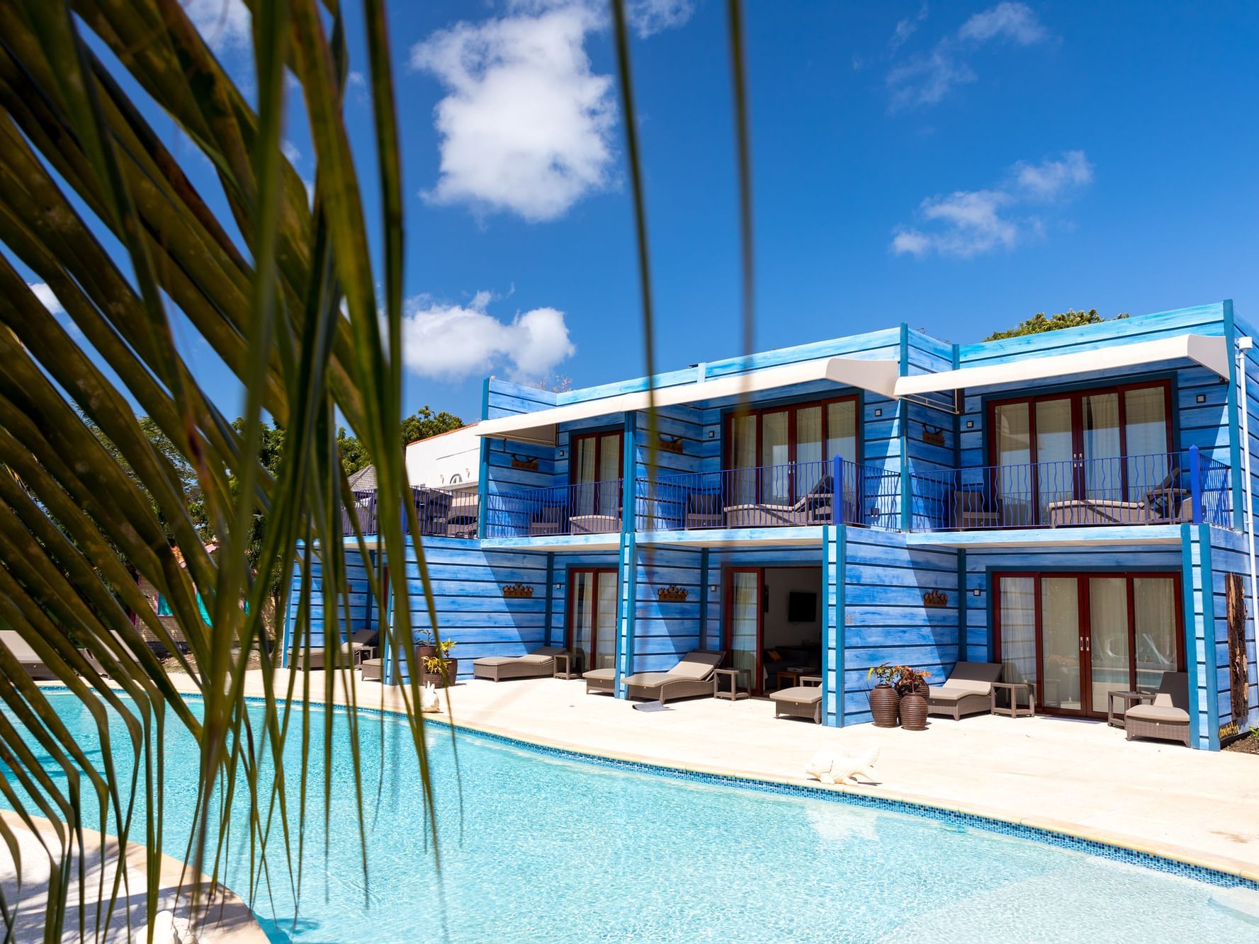 View of the outdoor pool & rooms at True Blue Bay Hotel