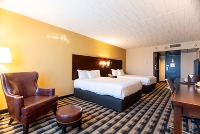 Leather lounge by the beds in Classic Two Queen Bedroom at M Hotel Buffalo