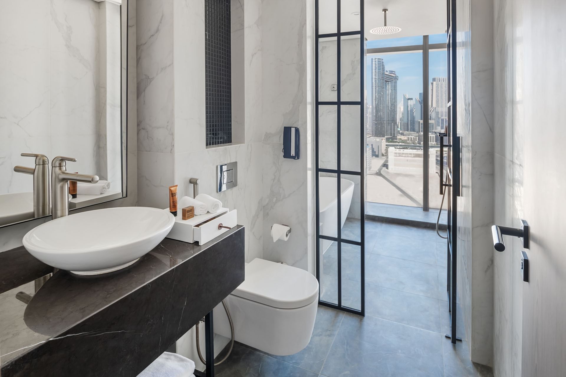 Bathroom vanity & bathtub overlooking the city in Co-Star Suite at Paramount Hotel Midtown