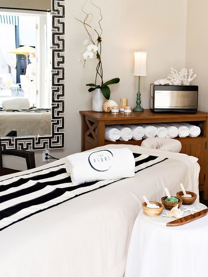 Spa bed arranged with amenities at Watersound Inn