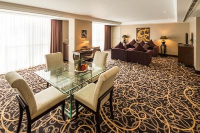 Living area with sofas & a dining area in Club Grand Executive Suite at Eastin Grand Hotel Saigon