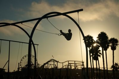 Silhouetted person using gymnast rings at Santa Monica Pier