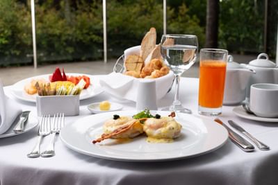 Desayuno servido con frutas, pan y jugo en el restaurante al aire libre en el Hotel Dann Carlton Medellín