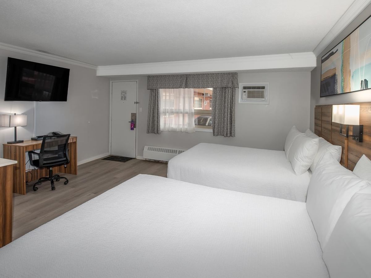 Two queen beds, kitchenette, and desk.