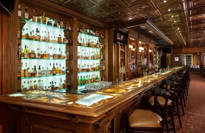 Whiskey Bar at Cascades Restaurant in The Stanley Hotel with a bar top and an extensive collection of liquor bottles