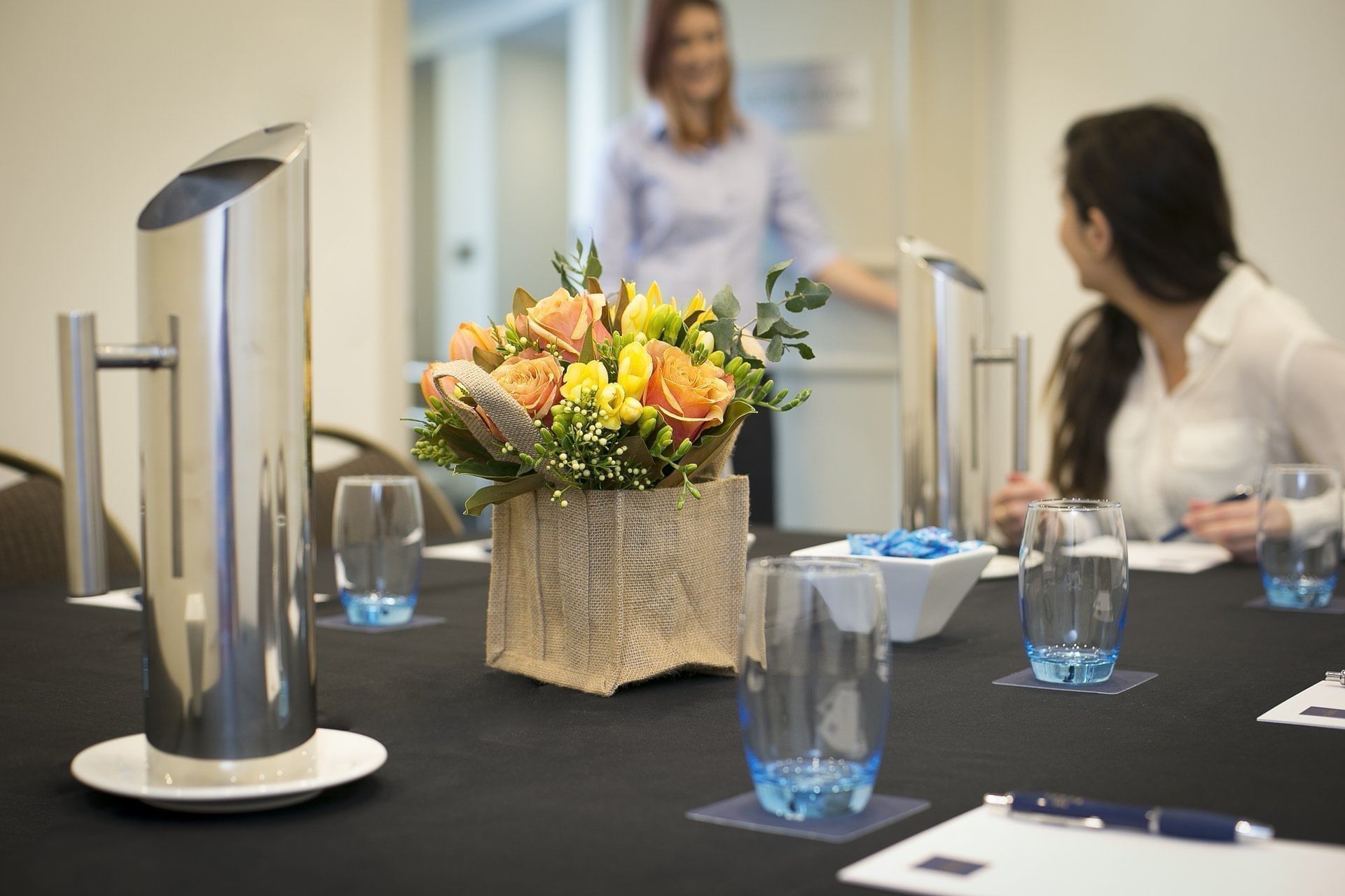 Two ladies discussing in the meeting room at the Sebel Residence Chatswood