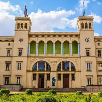 Low-angle view of Hamburger Bahnhof by garden near Titanic Hotels in Berlin
