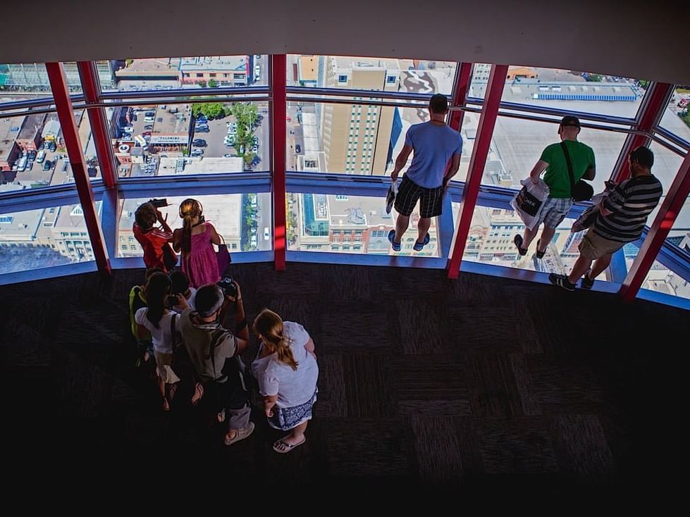 People looking around in Calgary Tower near Applause Hotel Calgary