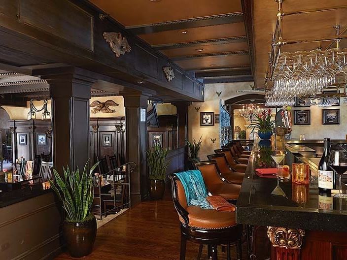bar with leather barstools and view to dining room