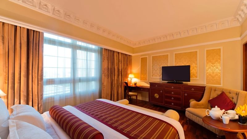 TV & work desk facing king bed in Executive Room at Warwick Doha