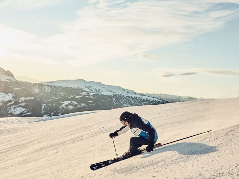 A skier sliding on a snowy mountain near Falkensteiner Hotels
