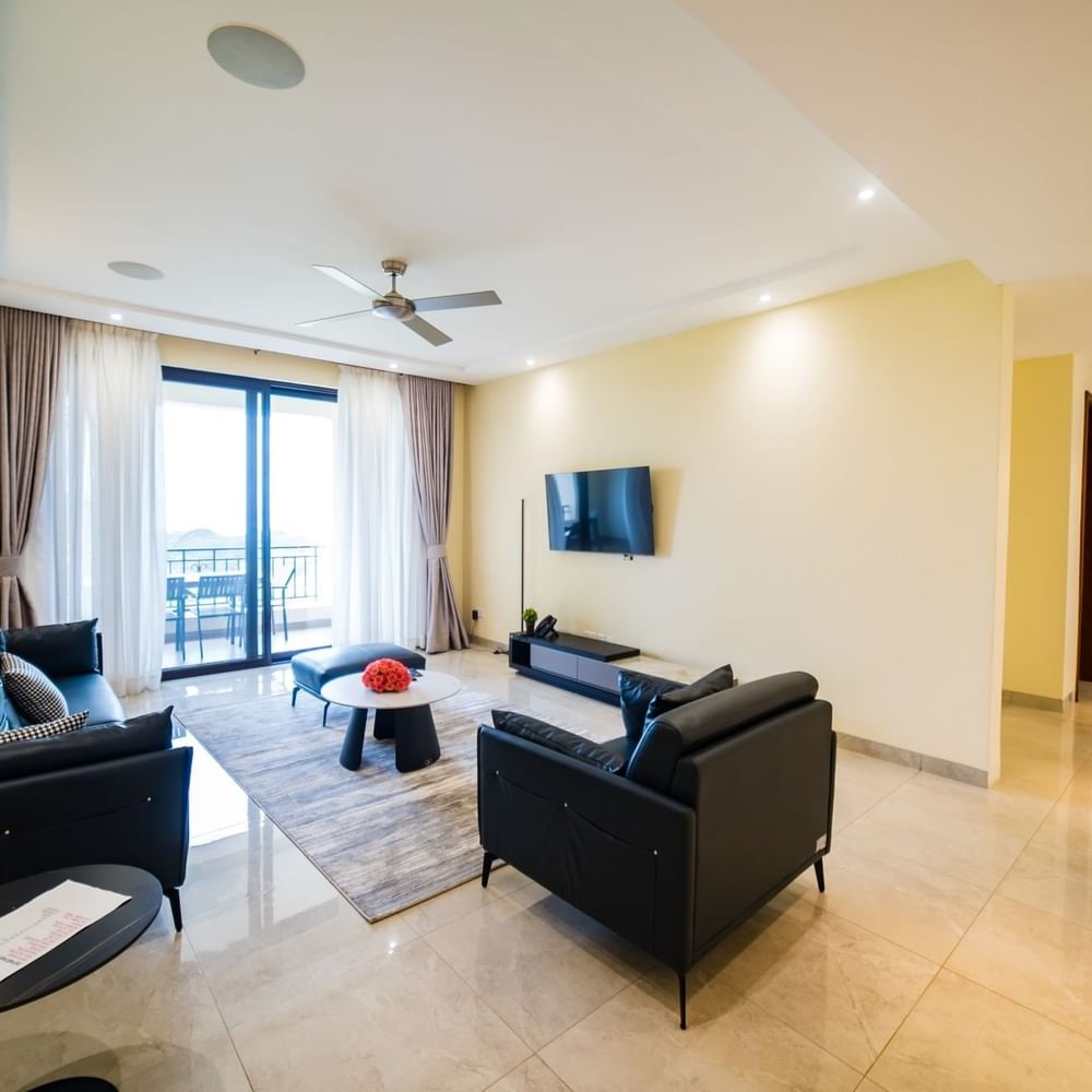 Elegant living room with black couches and modern decor at Lake Victoria Serena Golf Resort & Spa in Kampala.