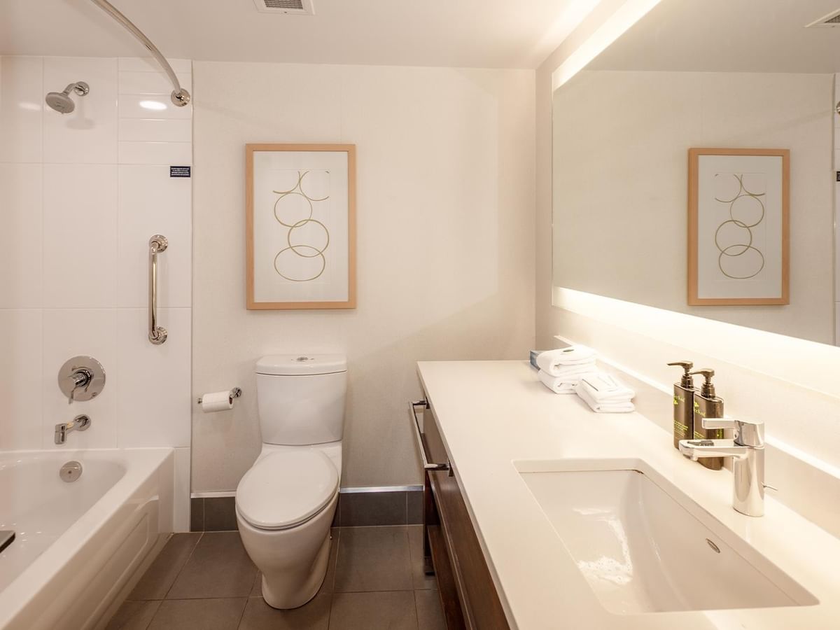 Clean bathroom with bathtub and toilet at Coast Bastion Hotel in Nanaimo.