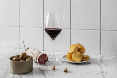 Close-up of red wine & snacks served at The Sparrow Hotel
