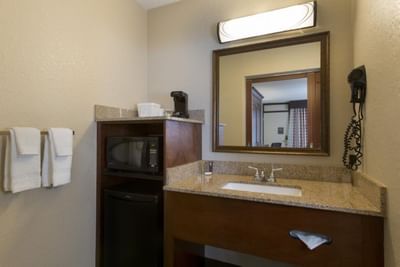 Bathroom vanity in Deluxe King Room at Rosen Inn at Pointe Orlando