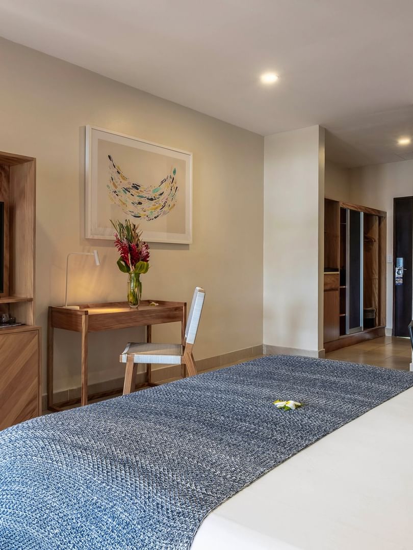 Lagoon Superior Room with bed, desk, couch, and TV at Warwick Le Lagon - Vanuatu, Efate.