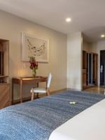 Lagoon Superior Room with bed, desk, couch, and TV at Warwick Le Lagon - Vanuatu, Efate.