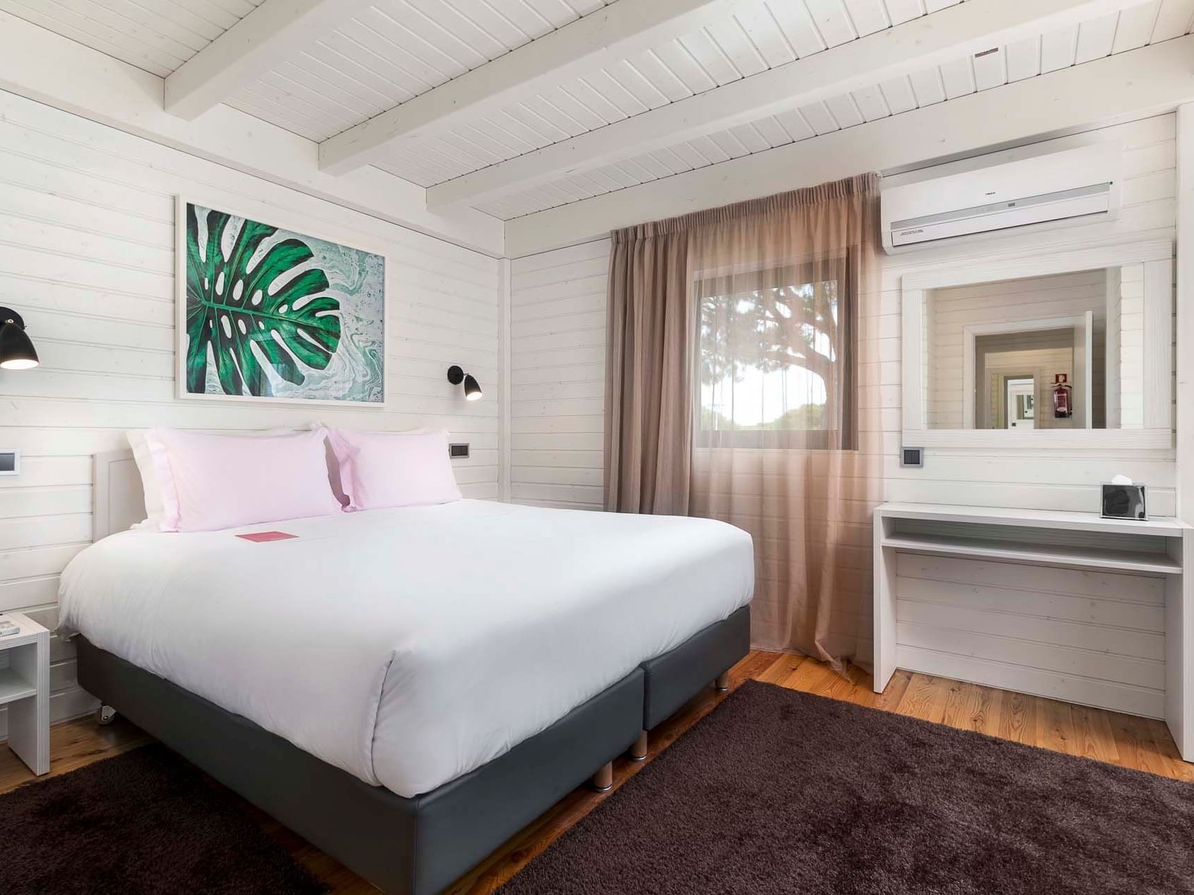 Cottage bedroom with a queen bed at The Magnolia Hotel