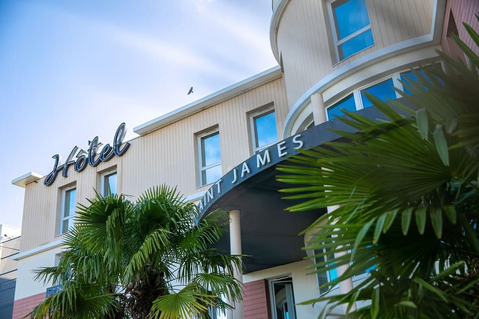 Saint James Hotel facade featuring signage, complemented by tropical plants