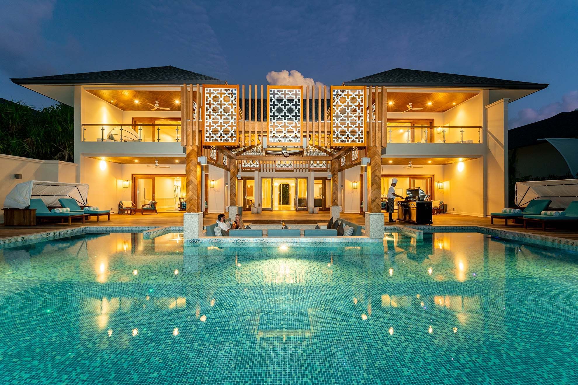 Exterior view of The Signature Collection & pool at night