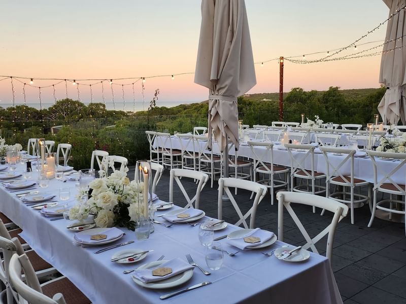 Long tables on outdoor balcony for wedding reception