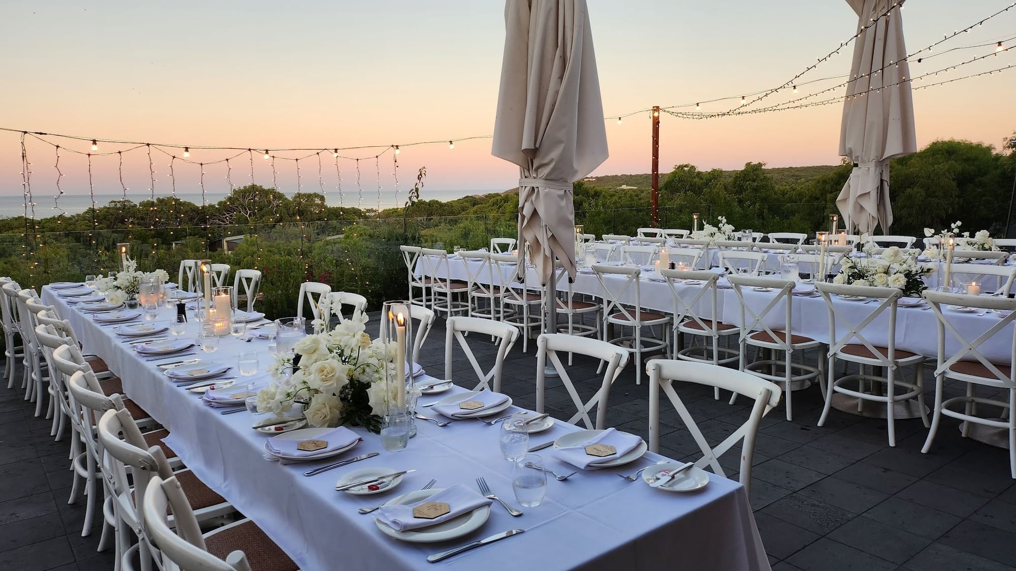 Long tables on outdoor balcony for wedding reception