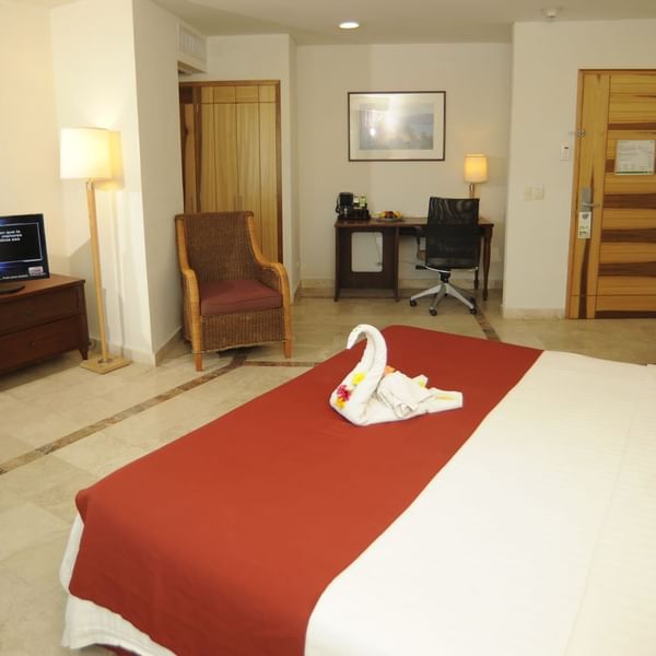 Bed & furniture in Junior Suite at Gamma Hotels