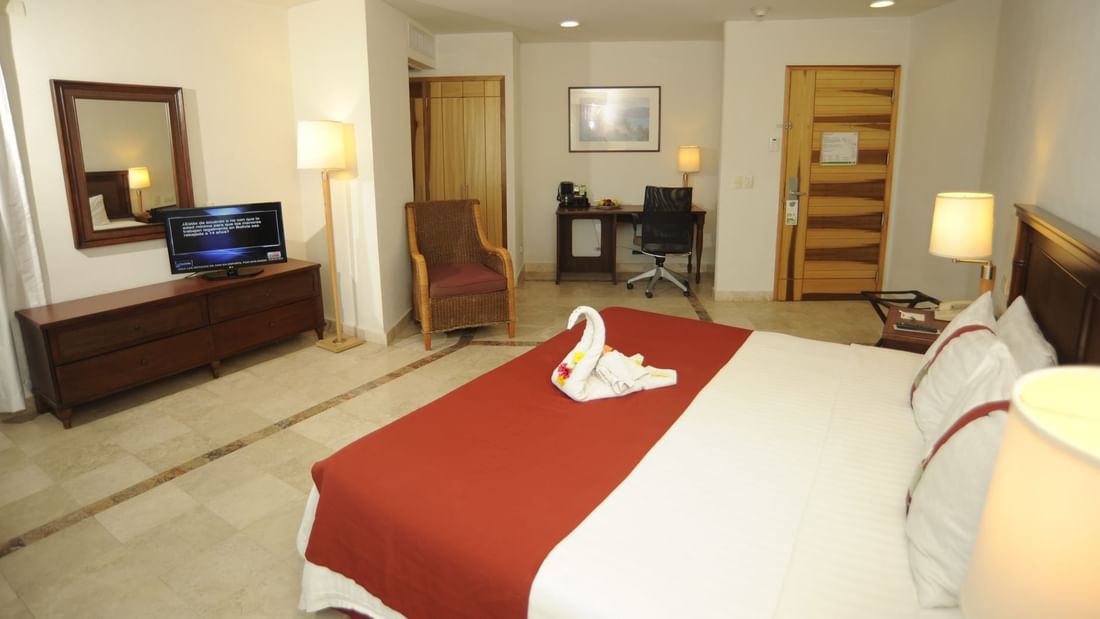 Bed & furniture in Junior Suite at Gamma Hotels