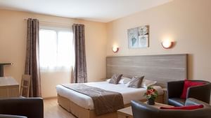 Interior of a double bed room at Hotel La Closerie