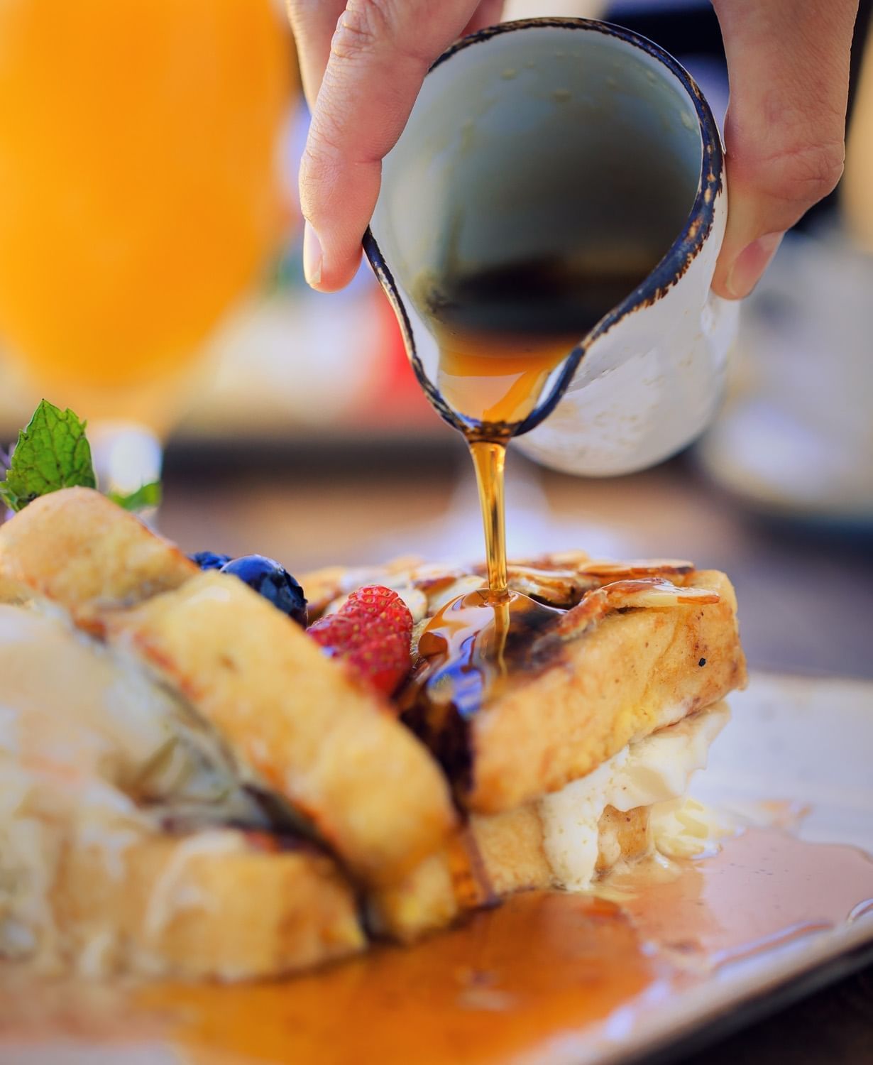 Cello Restaurant's french toast with syrup being poured over the