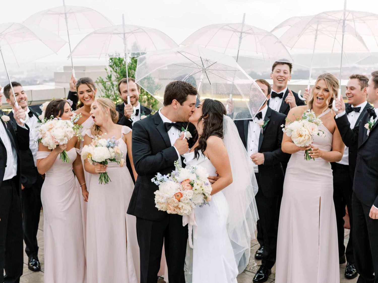 Wedded couple kissing on rooftop at The Mayo Hotel