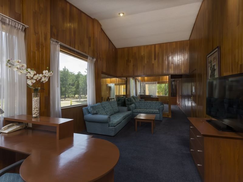 Junior Suite living room with a wooden finish at Gamma Hotels