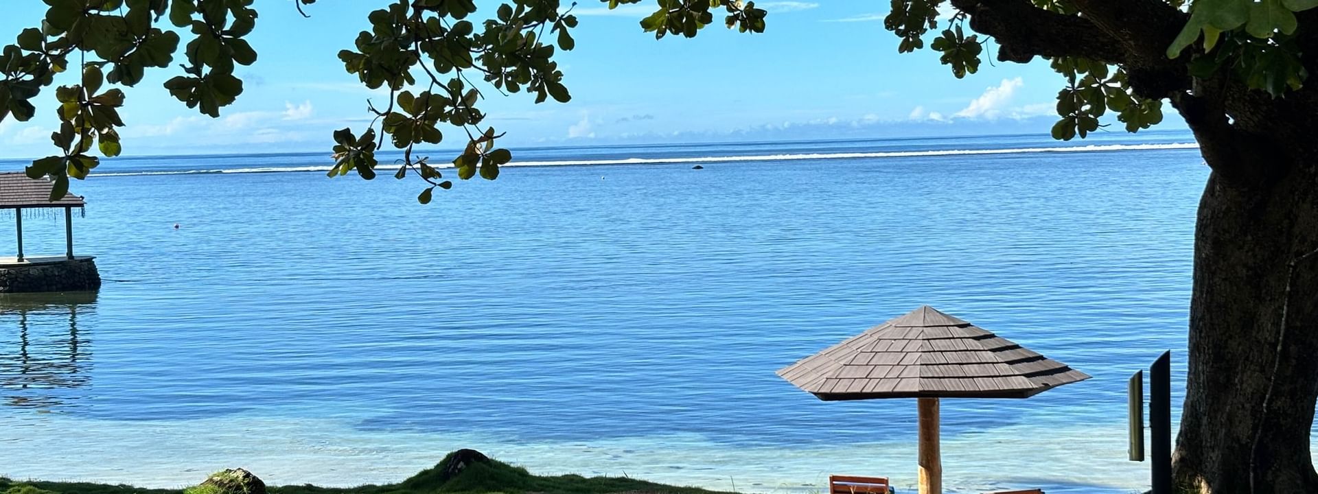 Umbrellas and benches on sand beach at Warwick Fiji Resort and Spa in Korolevu