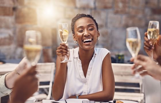 Lady & friends toasting champagne glasses at Azalai Hotel Dakar