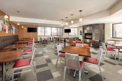Modern dining area with wooden tables and red chairs at Elevation Resort & Spa