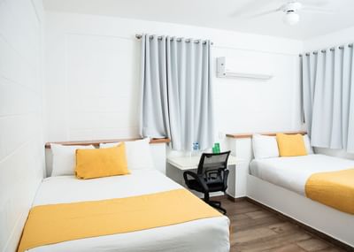 Twin beds and a working desk in Double Premium Room at Cha Cha Hotel