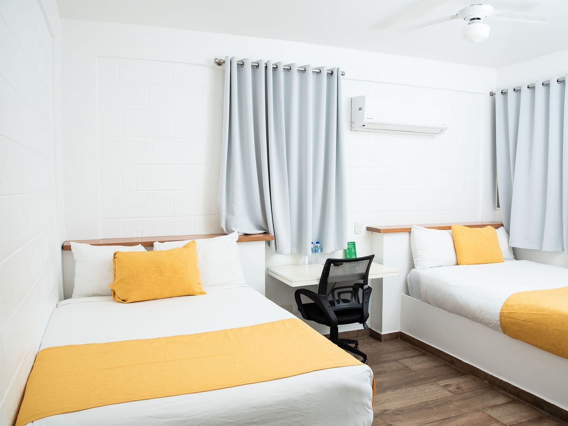 Twin beds and a working desk in Double Premium Room at Villas Codevi