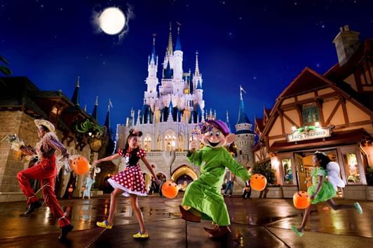 Characters in costume dancing at Disney’s Magic Kingdom near Lake Buena Vista Resort Village & Spa