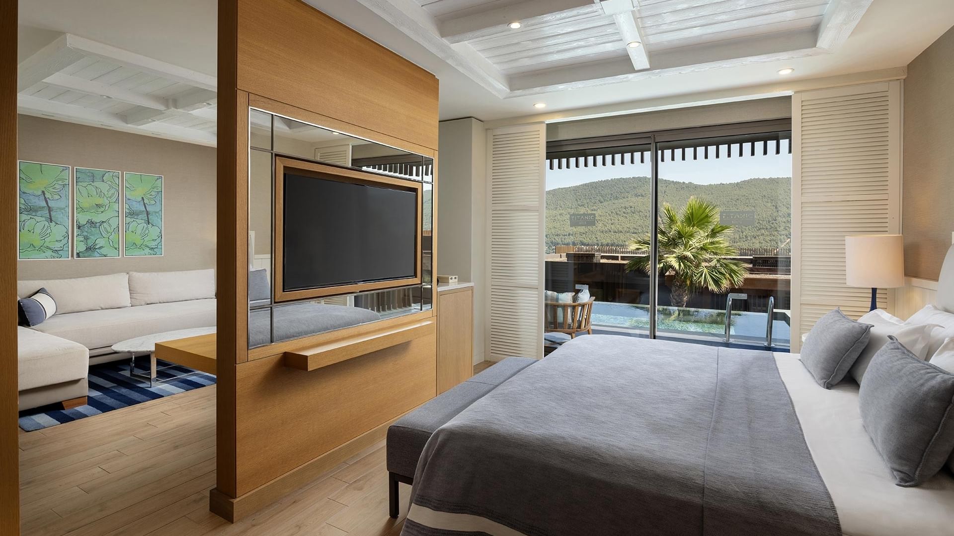 Interior of Swim-up Deluxe Room equipped with a shared pool & cozy bed at Titanic Luxury Collection Bodrum