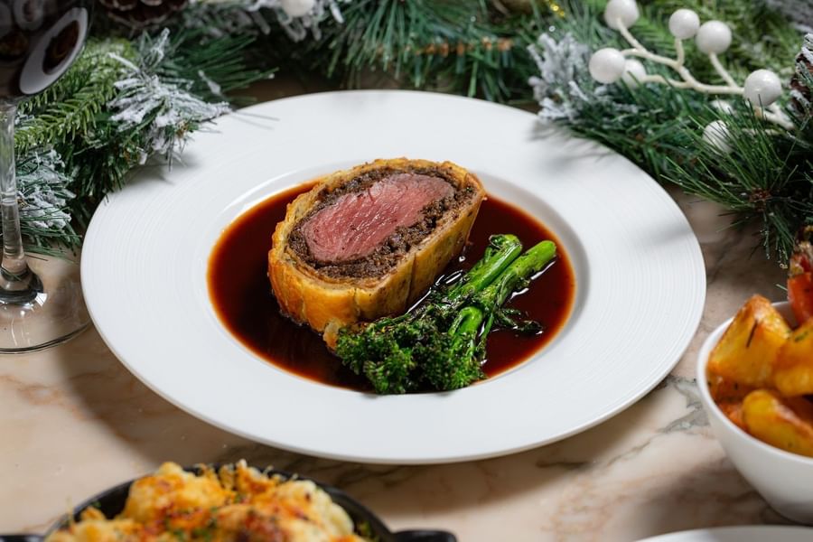 Served Aged beef Wellington with charred greens & red wine at The May Fair Hotel