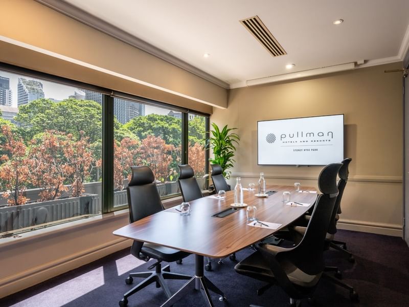 Boardroom set-up with TV in Busby Room at Pullman Sydney Hyde Park