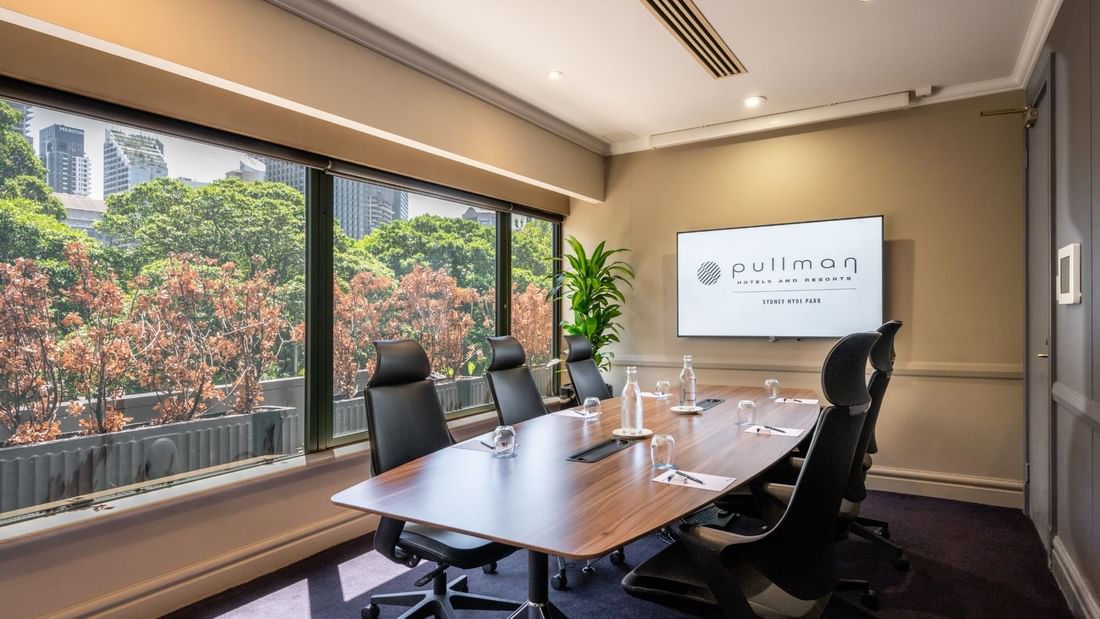 Boardroom set-up with TV in Busby Room at Pullman Sydney Hyde Park